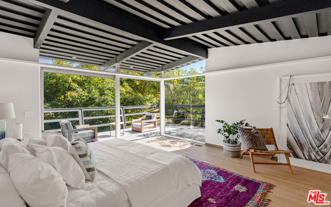 6009 Bonsall Drive Malibu, CA 90265 - Photo 19 of 49 a bed sitting in a bedroom next to a window