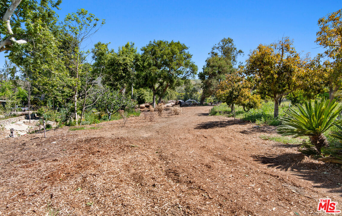 6009 Bonsall Drive Malibu, CA 90265 - Photo 25 of 49 a wooden bench with view of trees