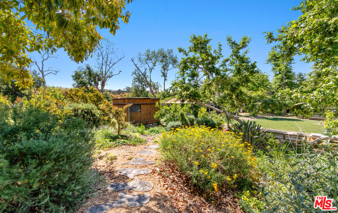 6009 Bonsall Drive Malibu, CA 90265 - Photo 34 of 49 a view of a garden with a lake