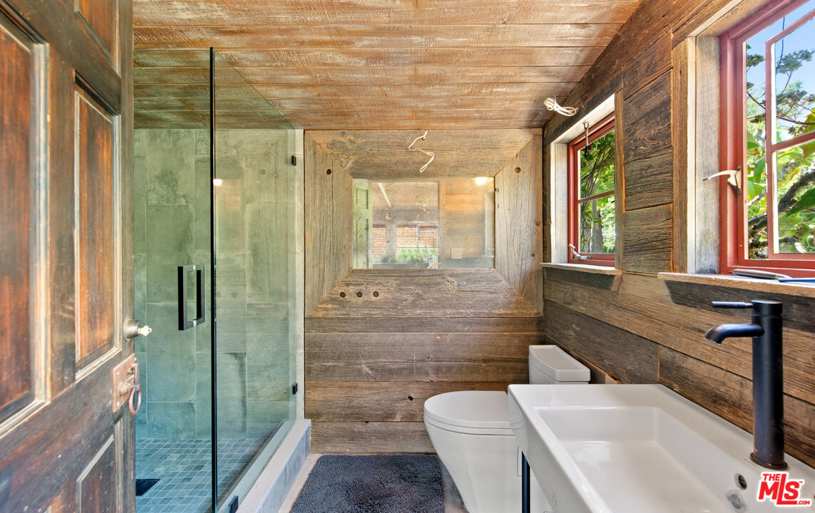 6009 Bonsall Drive Malibu, CA 90265 - Photo 45 of 49 a bathroom with a sink toilet and shower