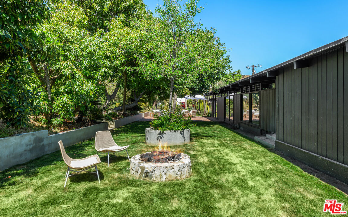6009 Bonsall Drive Malibu, CA 90265 - Photo 10 of 49 a view of two chairs in backyard of the house