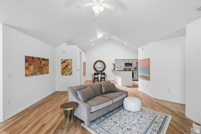 2047 West Abbey View Road, Unit 17C West Jordan, UT 84088 - Photo 20 of 50 Expansive living area featuring vaulted ceilings, wood-finish flooring, and recessed lighting