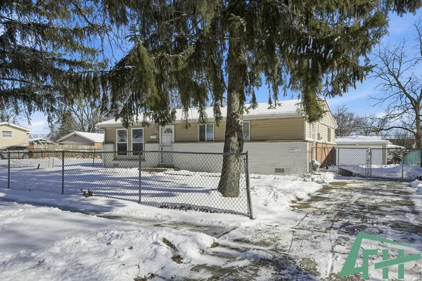 a view of a house with snow on the road