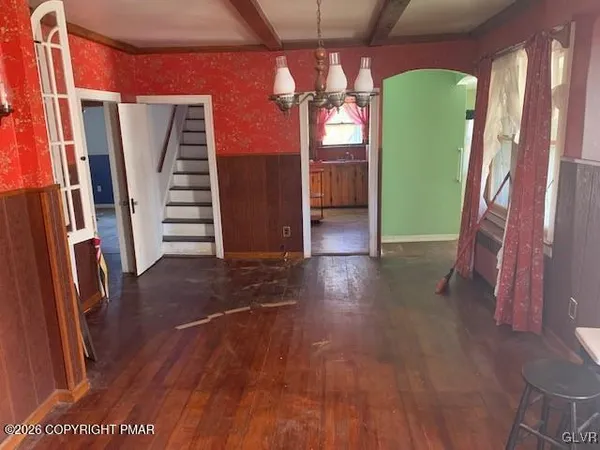 a view of a room with wooden floor and stairs