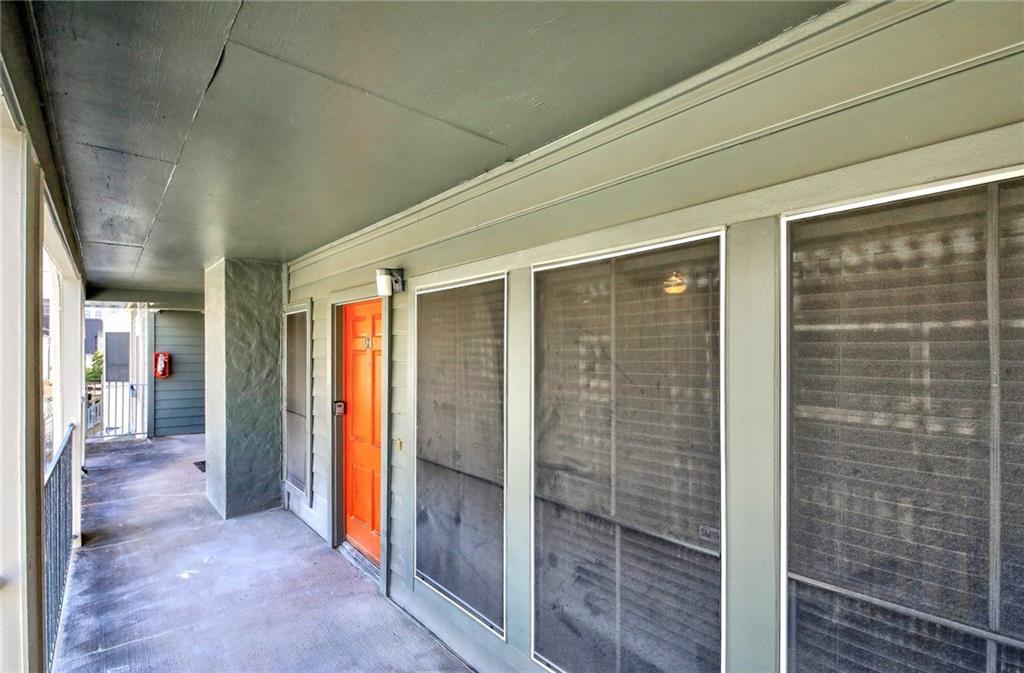 2529 Rio Grande Street, Unit 93 Austin, TX 78705 - Photo 18 of 19 The property features a private entrance with an orange door and screened windows
