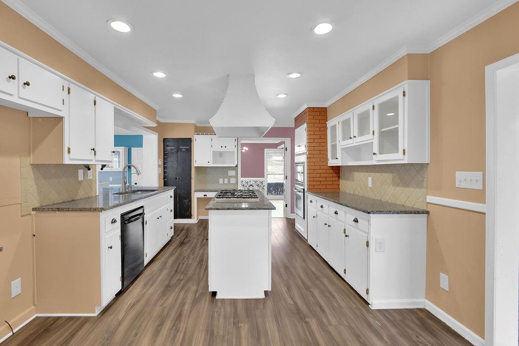 326 Fayette Drive Winder, GA 30680 - Photo 13 of 57 a kitchen with granite countertop a stove top oven a sink a counter space and cabinets