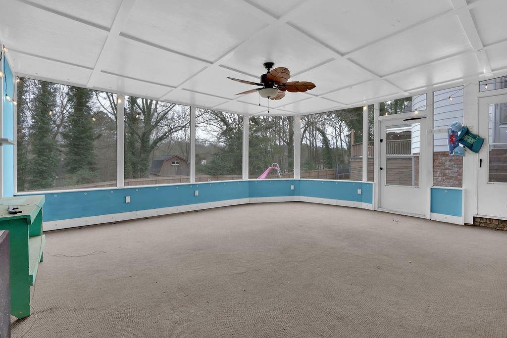 326 Fayette Drive Winder, GA 30680 - Photo 27 of 57 a view of an empty room with a floor to ceiling window and stairs