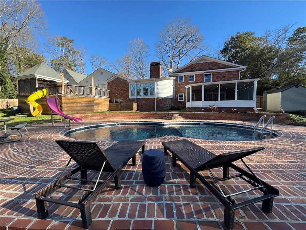 326 Fayette Drive Winder, GA 30680 - Photo 36 of 57 a view of a patio with swimming pool table and chairs