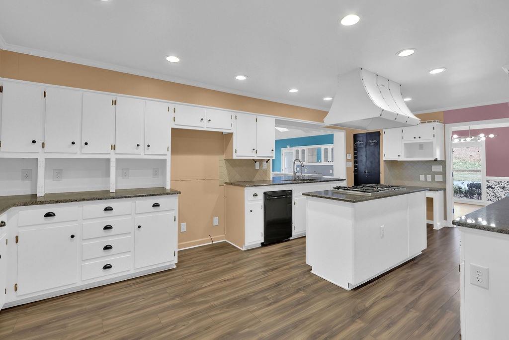 326 Fayette Drive Winder, GA 30680 - Photo 4 of 57 a kitchen with stainless steel appliances white cabinets and wooden floors
