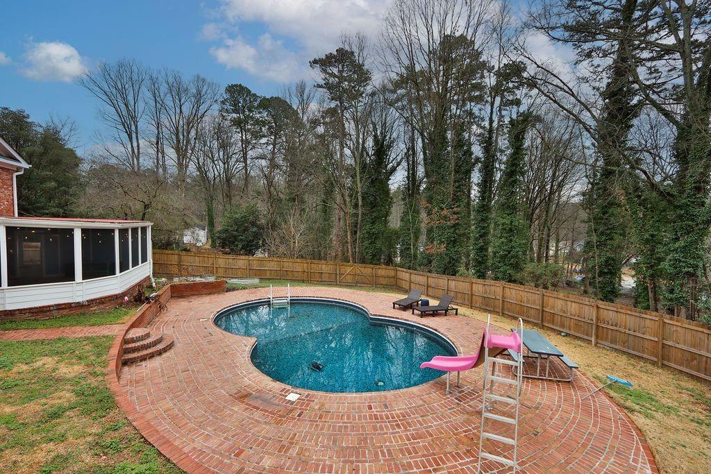 326 Fayette Drive Winder, GA 30680 - Photo 53 of 57 a view of a swimming pool with a patio