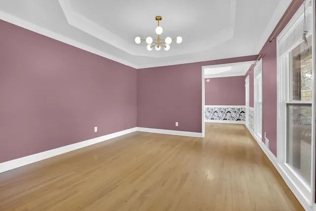 a view of an empty room with a chandelier