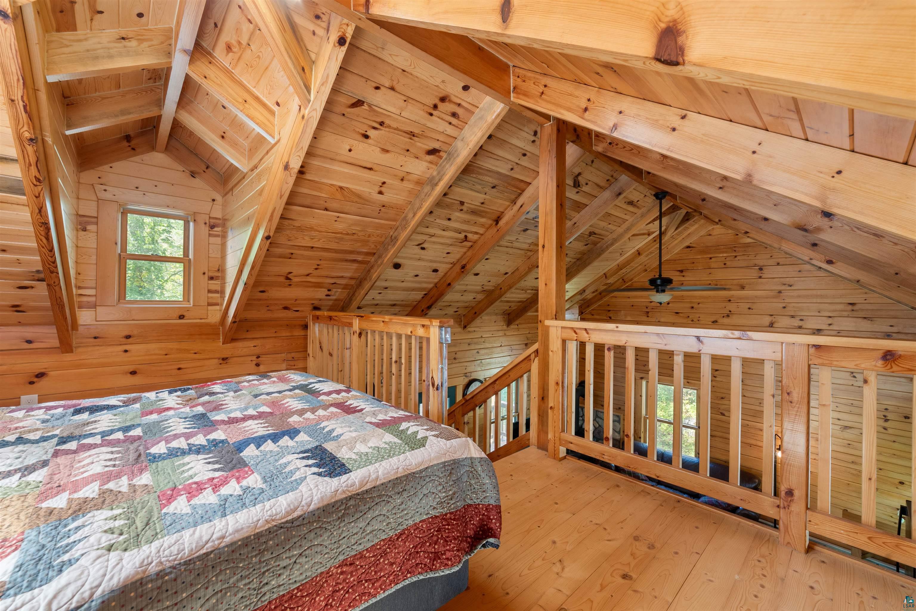 6711 South Jem Lane Lake Nebagamon, WI 54849 - Photo 15 of 28 Bedroom with wooden ceiling, wooden walls, and hardwood / wood-style flooring