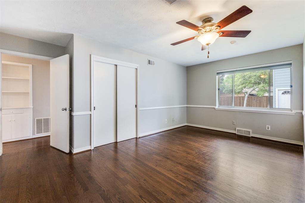 7128 Haverford Road Dallas, TX 75214 - Photo 11 of 24 an empty room with wooden floor and windows