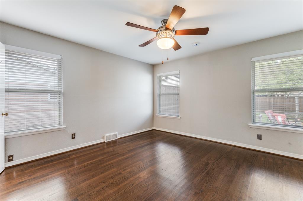 7128 Haverford Road Dallas, TX 75214 - Photo 14 of 24 an empty room with wooden floor fan and windows