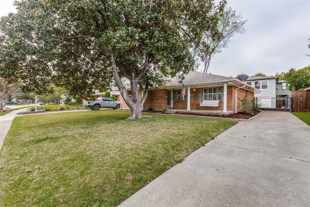 7128 Haverford Road Dallas, TX 75214 - Photo 2 of 24 a front view of a house with a yard