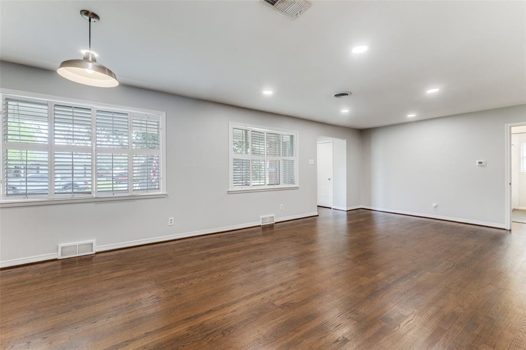 7128 Haverford Road Dallas, TX 75214 - Photo 3 of 24 an empty room with wooden floor and windows