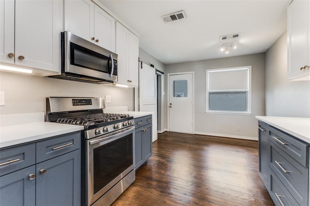 7128 Haverford Road Dallas, TX 75214 - Photo 7 of 24 a kitchen with a stove and a microwave