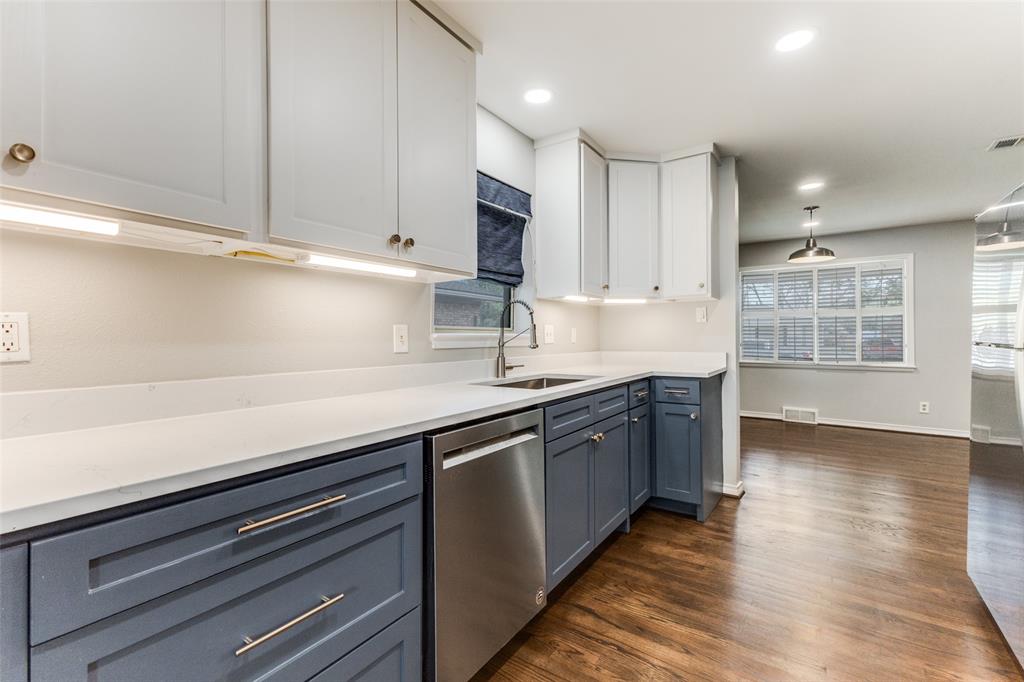 7128 Haverford Road Dallas, TX 75214 - Photo 9 of 24 a kitchen with stainless steel appliances granite countertop a sink dishwasher a stove and a microwave oven on granite countertops