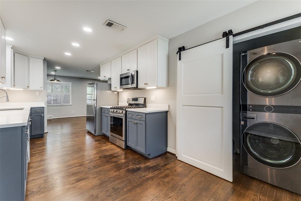 7128 Haverford Road Dallas, TX 75214 - Photo 10 of 24 a kitchen with stainless steel appliances granite countertop a refrigerator a stove and a wooden floors