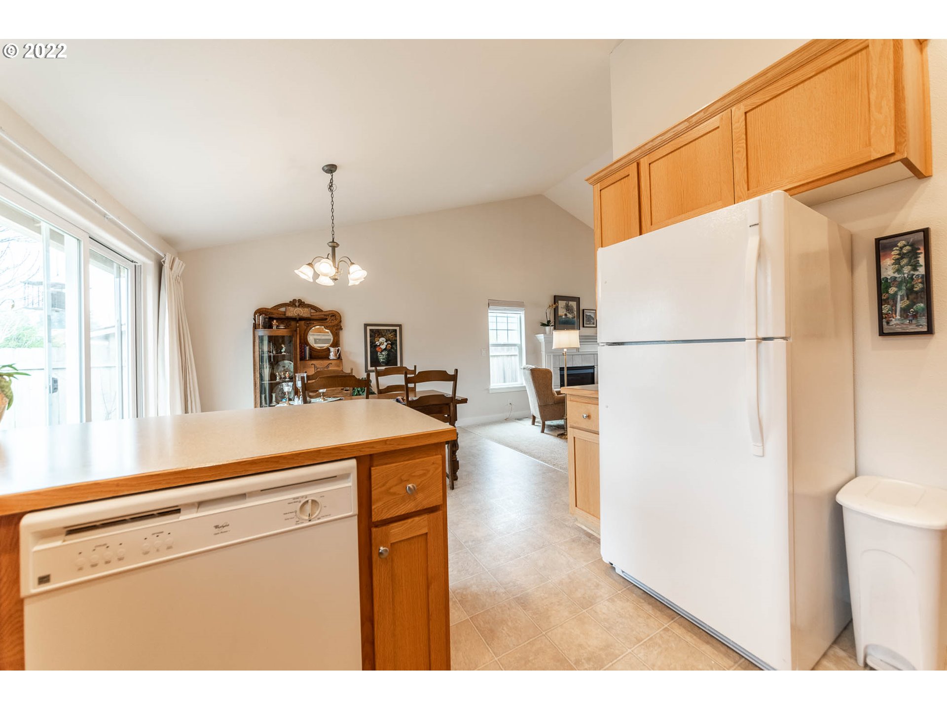 4019 Douglas Drive Springfield, OR 97478 - Photo 11 of 32 a kitchen with a refrigerator a stove a sink a dining table and chairs