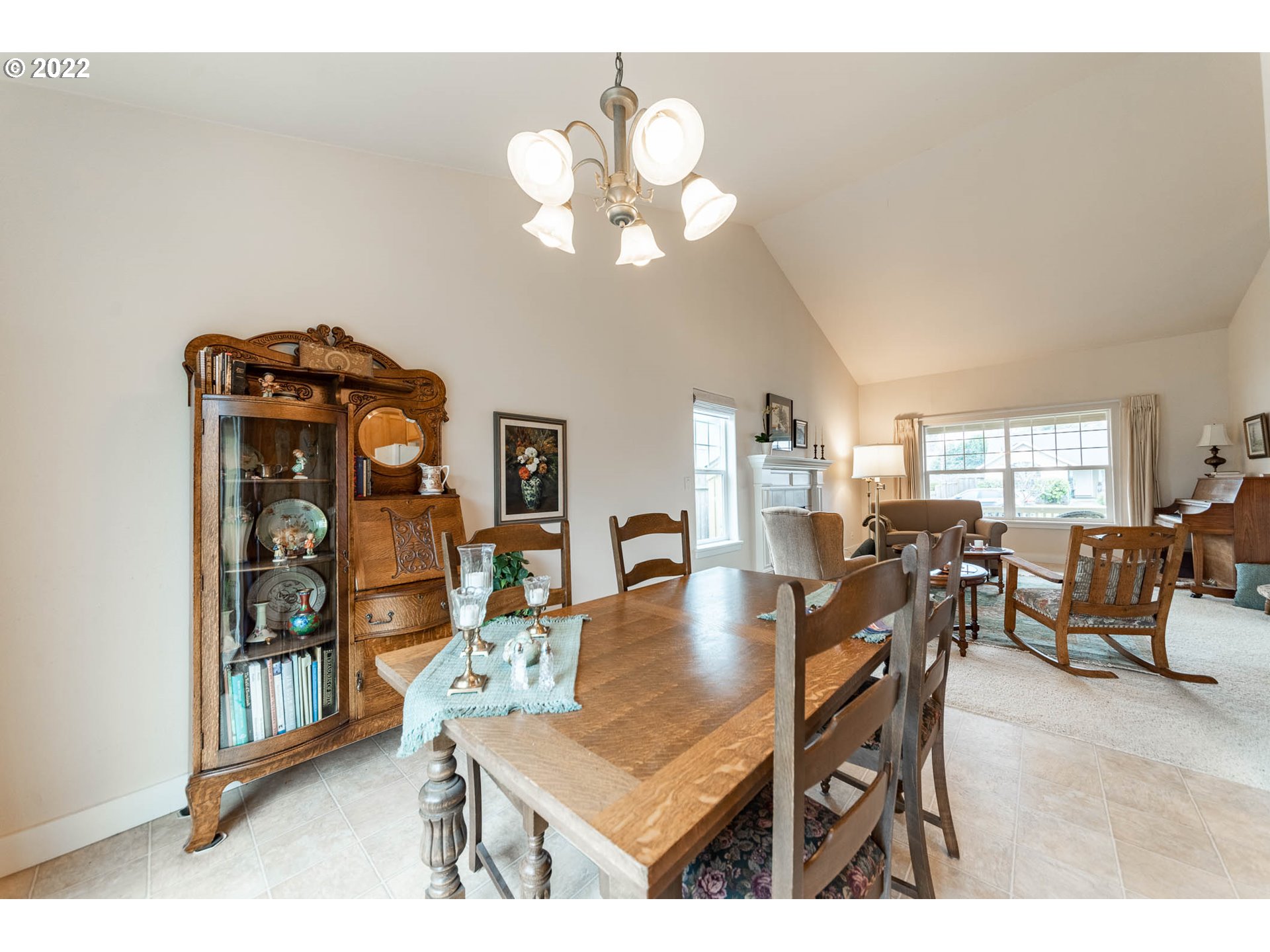 4019 Douglas Drive Springfield, OR 97478 - Photo 12 of 32 a dining room with wooden floor a chandelier a wooden table and chairs