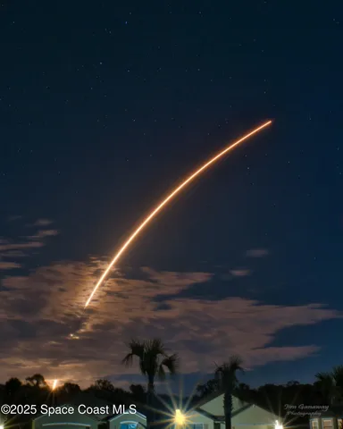 a view of a lake with houses in the back