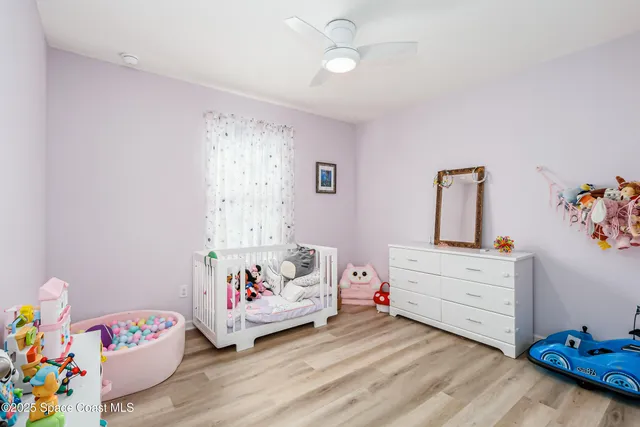 a living room with furniture a ceiling fan and a window