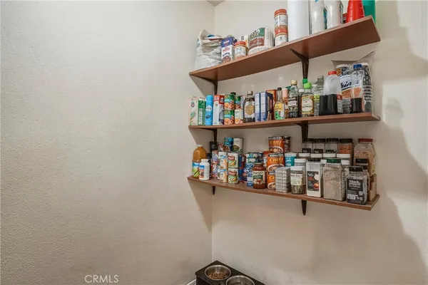 a room with storage and a white refrigerator