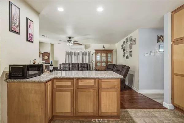 a kitchen with stainless steel appliances granite countertop a sink and a refrigerator