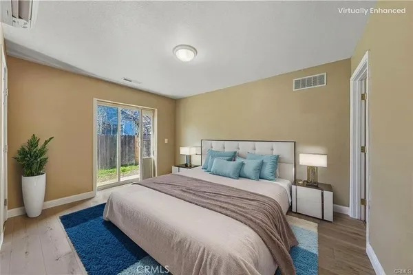 a bedroom with a large bed and a potted plant