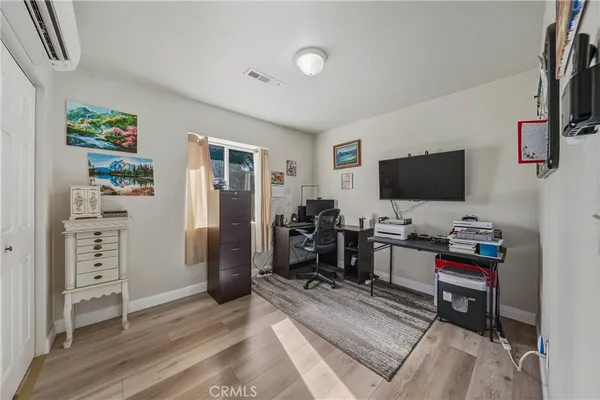 a view of a livingroom with furniture and a flat screen tv