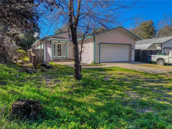 a house that has a tree in front of it