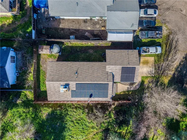 an aerial view of a house with a yard