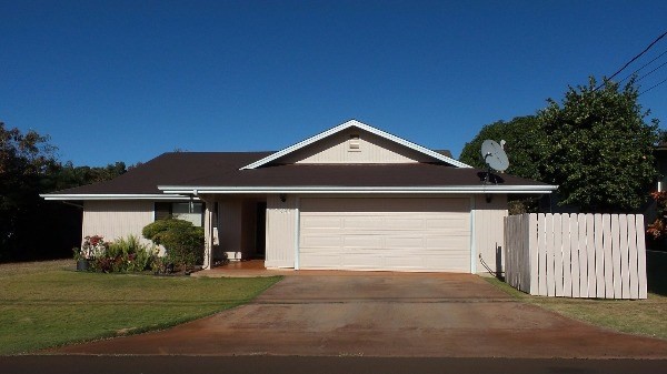 4891 Alii Road Hanapepe, HI 96716 - Photo 1 of 25 a front view of a house with a yard and garage