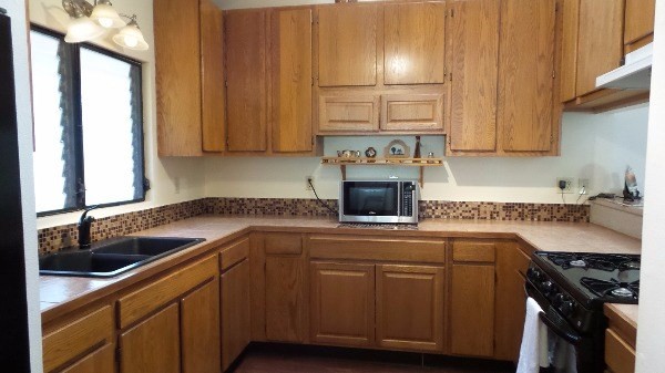 4891 Alii Road Hanapepe, HI 96716 - Photo 8 of 25 a kitchen with stainless steel appliances granite countertop a sink stove and refrigerator