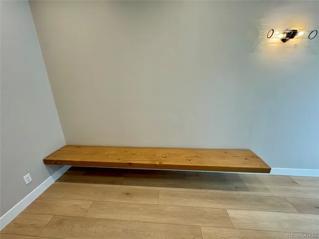 a view of entryway and gallery with wooden floor