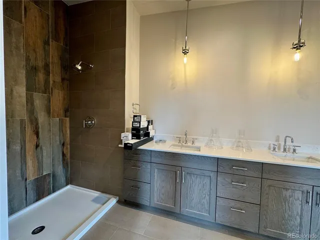 a bathroom with a tub sink and mirror
