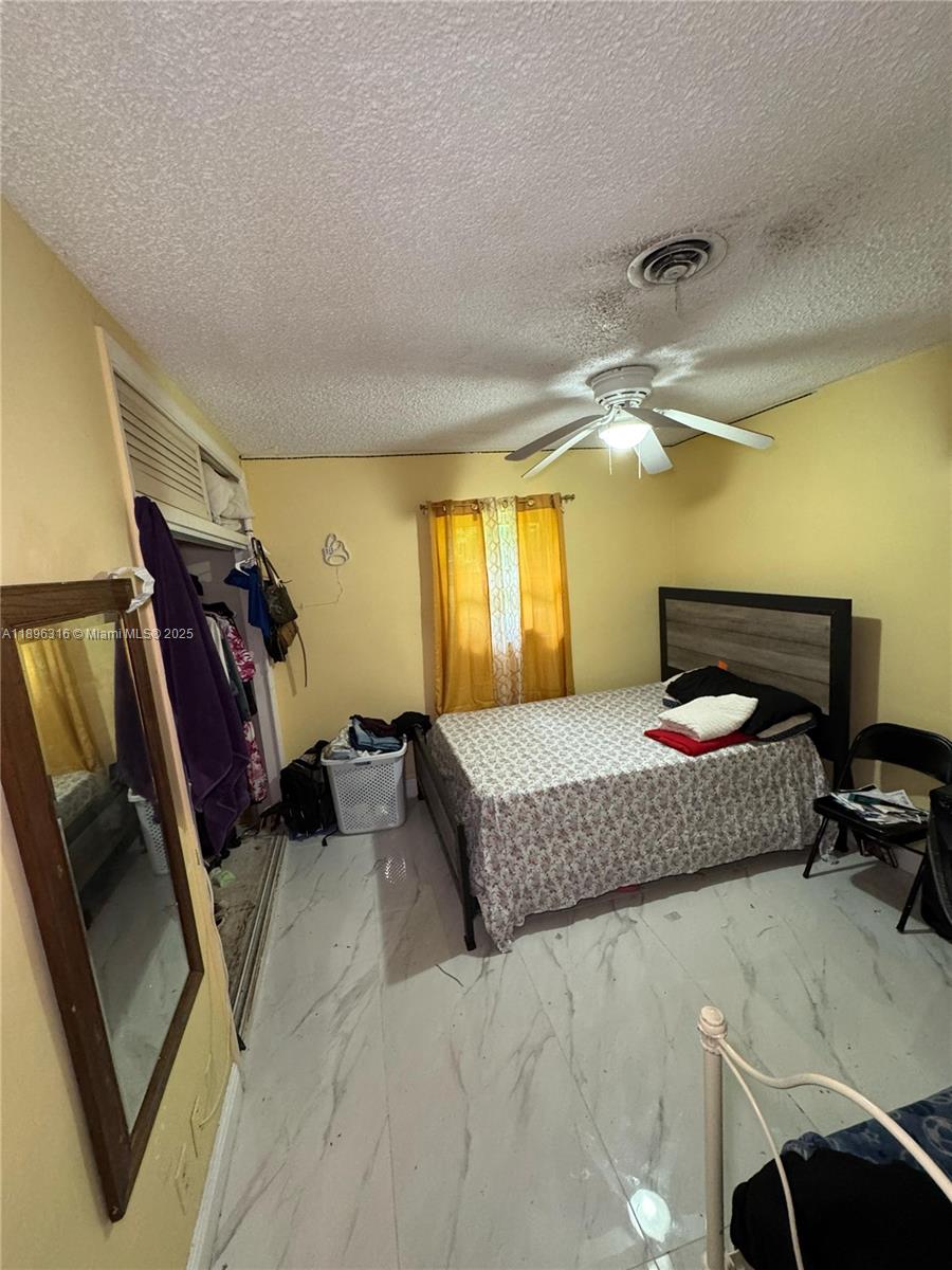 3405 Northwest 82nd Avenue Coral Springs, FL 33065 - Photo 17 of 26 a bedroom with a bed and wooden floor