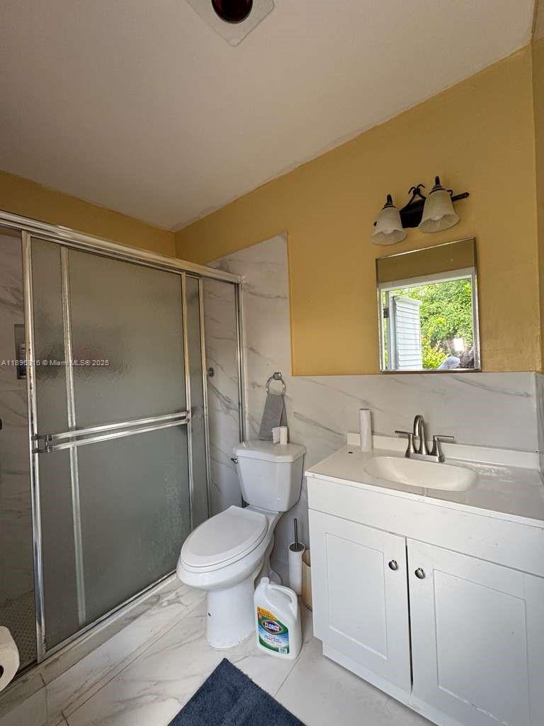 3405 Northwest 82nd Avenue Coral Springs, FL 33065 - Photo 18 of 26 a white toilet sitting next to a bathroom sink