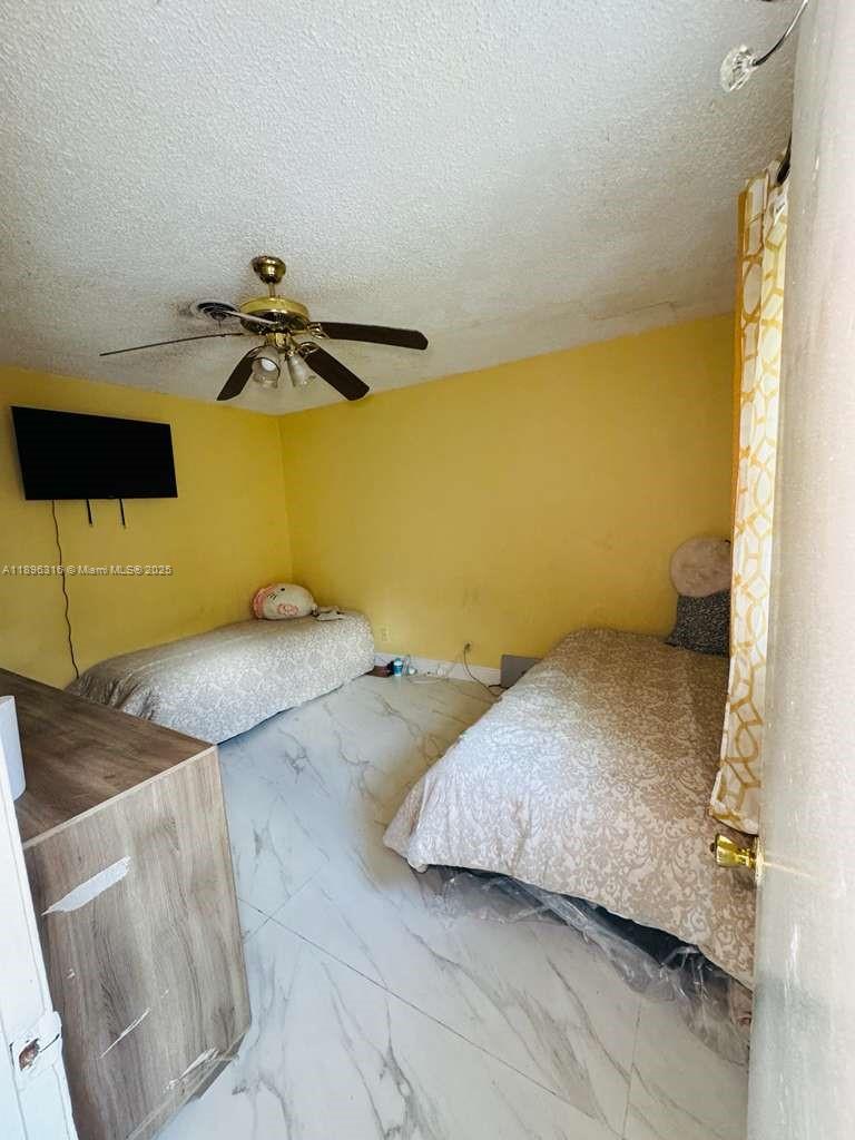 3405 Northwest 82nd Avenue Coral Springs, FL 33065 - Photo 10 of 26 a bedroom with a bed and ceiling fan