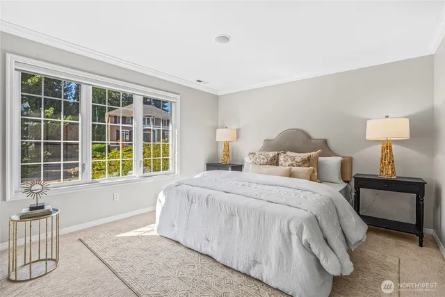 a bedroom with a bed and a large window
