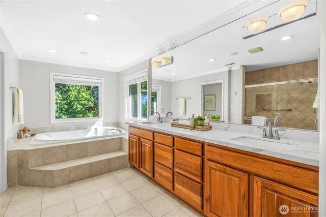 a spacious bathroom with a tub sink and mirror