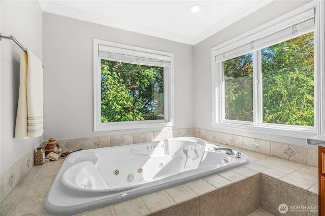 a bath tub sitting in a bathroom next to a window