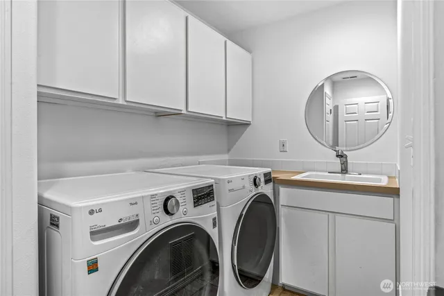 a utility room with sink dryer and washer