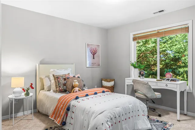 a bedroom with a bed and a large window