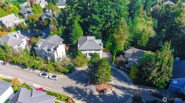 an aerial view of a house with a yard and garden