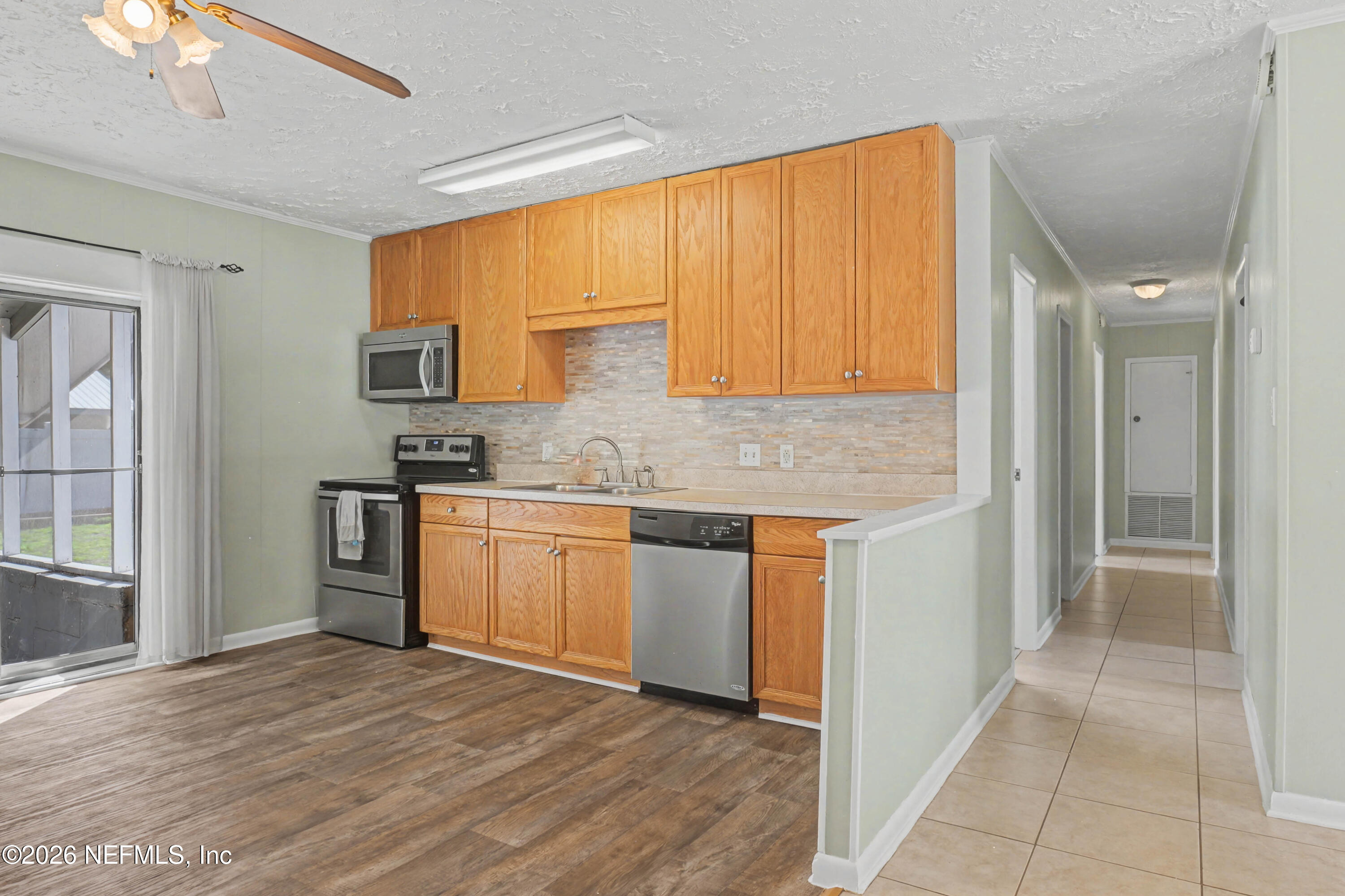 215 Orchis Road St. Augustine, FL 32086 - Photo 11 of 51 a kitchen with stainless steel appliances granite countertop a refrigerator sink and cabinets