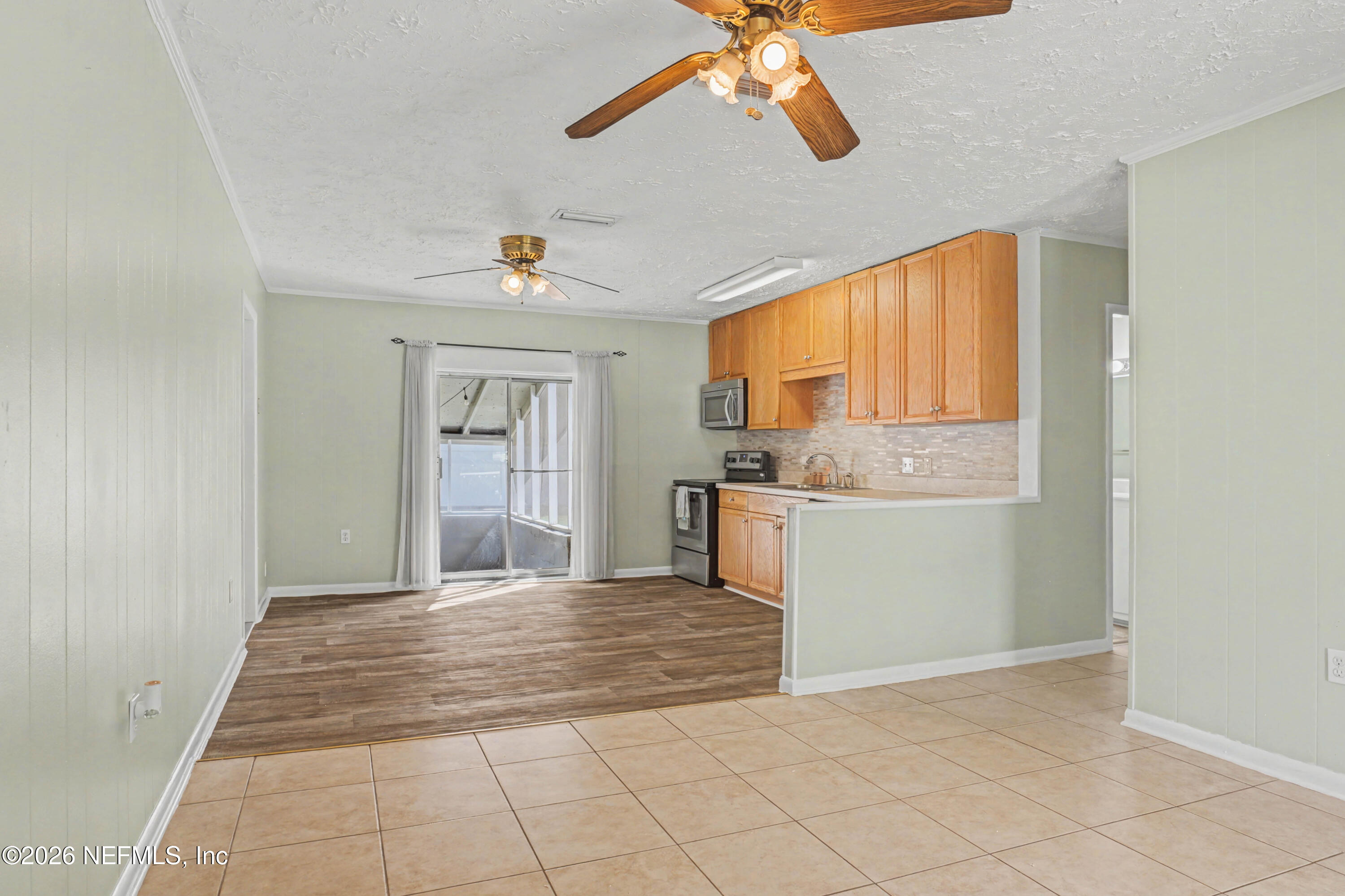 215 Orchis Road St. Augustine, FL 32086 - Photo 12 of 51 a view of a kitchen with microwave and windows