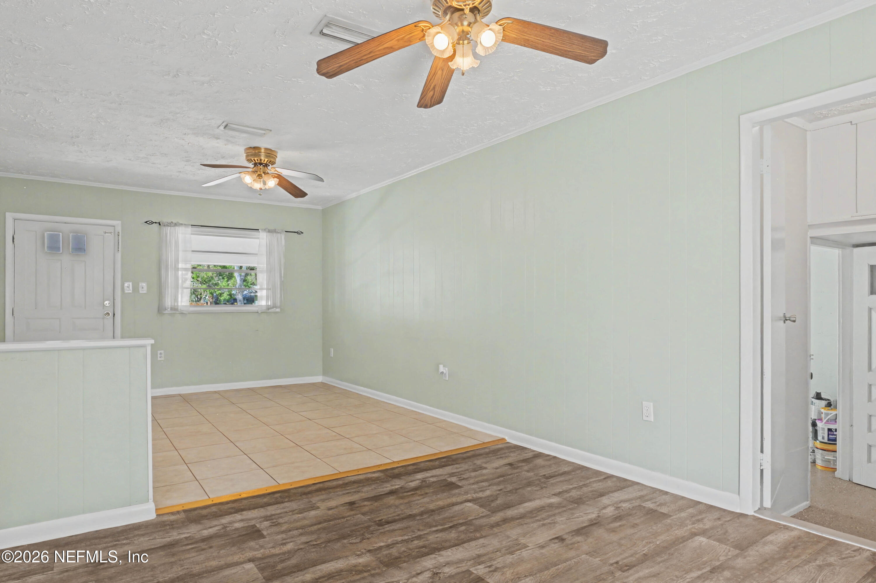 215 Orchis Road St. Augustine, FL 32086 - Photo 14 of 51 an empty room with windows and chandelier fan