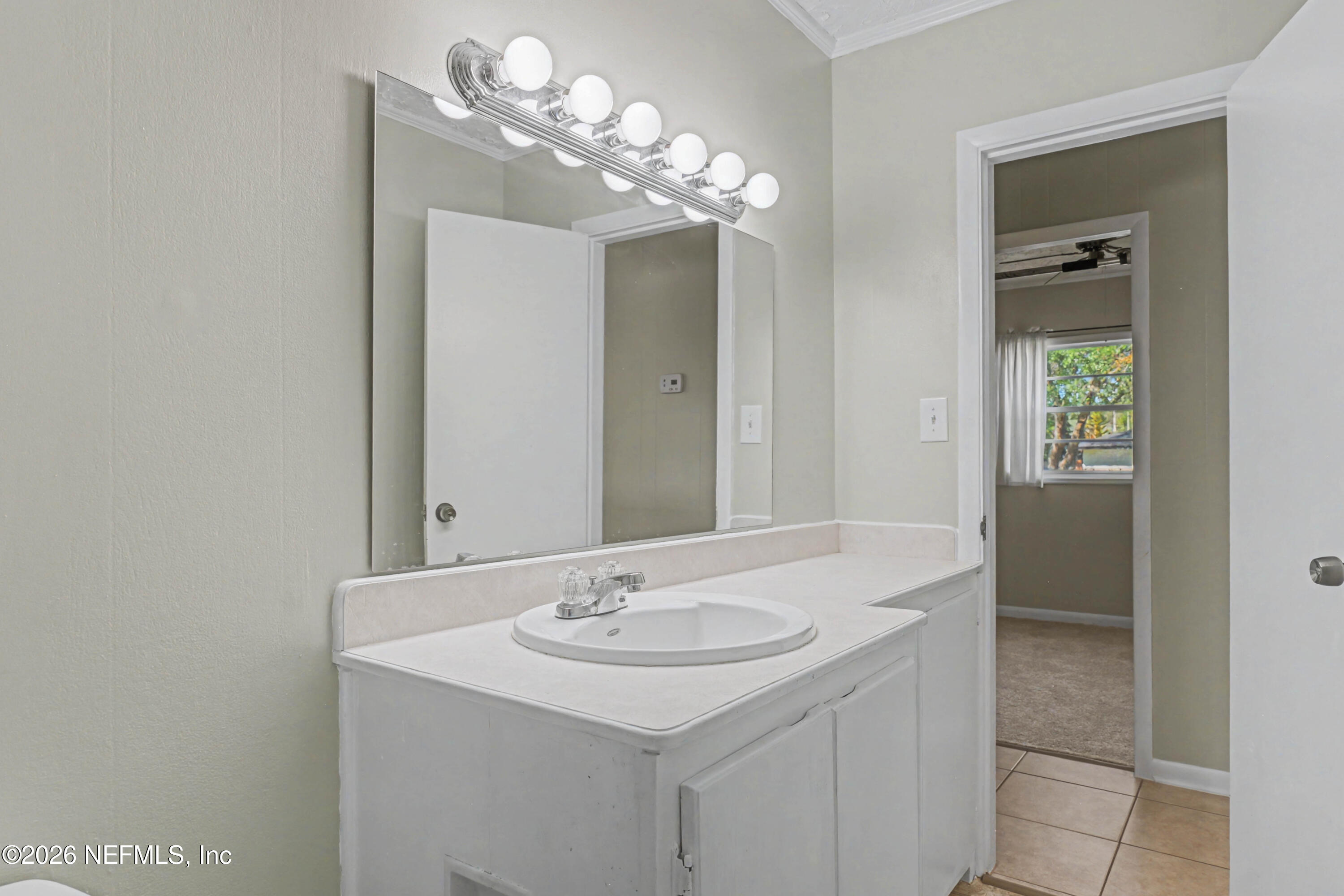 215 Orchis Road St. Augustine, FL 32086 - Photo 21 of 51 a bathroom with a sink and a mirror